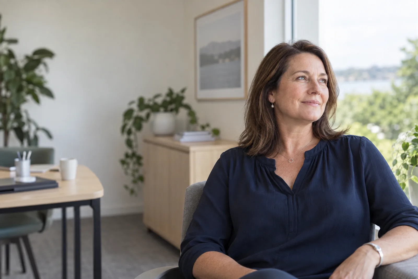 Illustrative portrait of a relaxed business owner in a light-filled office